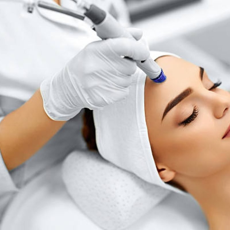 Face Skin Care. Close-up Of Woman Getting Facial Hydro Microdermabrasion Peeling Treatment At Cosmetic Beauty Spa Clinic. Hydra Vacuum Cleaner. Exfoliation, Rejuvenation And Hydratation. Cosmetology.